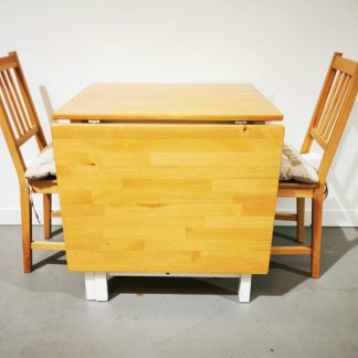 Ikea PINNTORP drop Leaf table with two chairs and cushion pads.